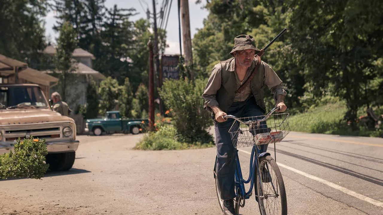 Ralph rides a bicycle along the road